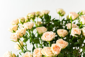 A bouquet of delicate cream roses close up, home decoration with flowers, a festive bouquet of roses for a birthday or wedding