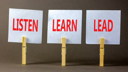 Listen learn lead symbol. Concept word Listen Learn Lead on beautiful white paper on wooden...