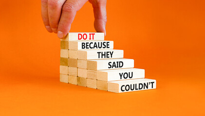 You can do it symbol. Concept words Do it because they said you could not on wooden block. Beautiful orange table background. Businessman hand. Business, motivational you can do it concept. Copy space - obrazy, fototapety, plakaty