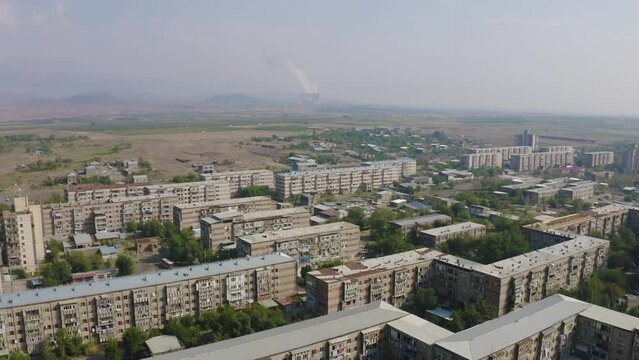 Forward reveal aerial shot of Metsamor town and Nuclear Power Plant on sunny summer day. Armenia.