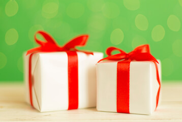 Christmas gifts on table against blurred lights