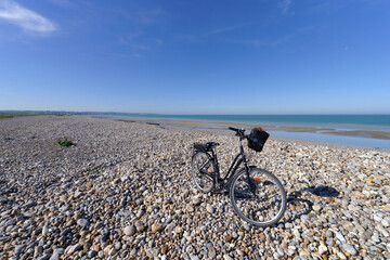 Bicycle on the Sea-wall of pebbles   
 of Ault village in Picardy coast