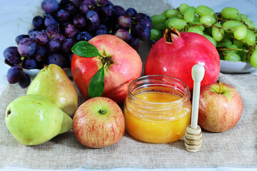 Honey, Apples, Pears, pomegranates, grapes - fruit composition still life for the Jewish New Year. Honey and Apples and pomegranates are the main symbols of Jewish holiday Rosh Hashanah
