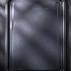 Empty gray tray on the table, kitchen utensils
