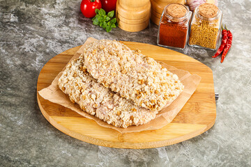 Breaded raw breaded meat schnitzel
