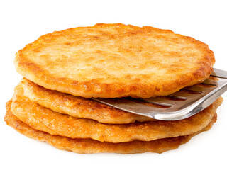 Stack of potato pancakes with spatula isolated on white.