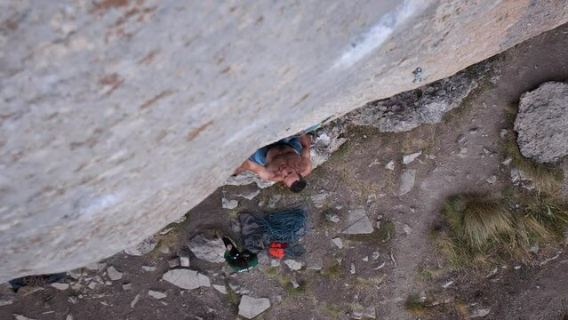 Young man lead climbing a hard and steep section of the wall in C&eacute;&uuml;se, France.
Following camera movement, low angle, 4K.