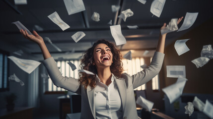 Obraz premium Happy businesswoman throwing papers in the air as a sign of victory and success in her work