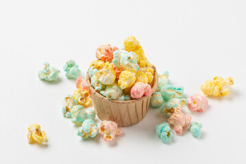 Hight angle of color sweet  popcorn poured out kraft paper form and scattered on a white background  isolated