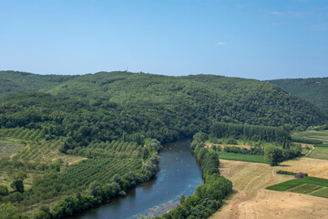 Aerial landscape view on Dordogne river with the old bridge and beautiful fields near Domme village...