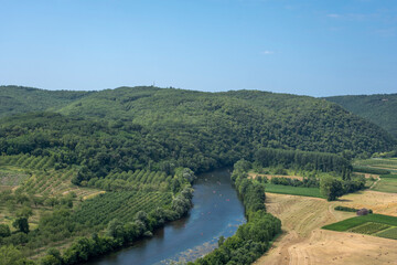 Fototapeta na wymiar Aerial landscape view on Dordogne river with the old bridge and beautiful fields near Domme village in France