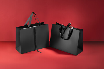 Mockup of a black paper bag with handles and bow ties