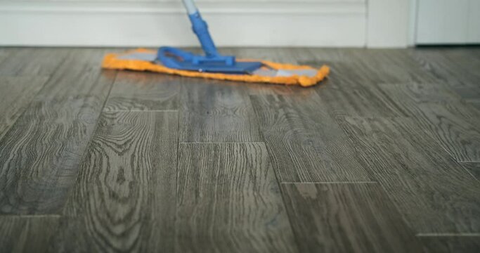 A mop deftly glides across the floor, efficiently removing dirt and grime. In a choreographed dance, the tool and water work together to leave a trail of cleanliness in their wake.