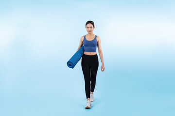 Fototapeta na wymiar Young attractive asian woman portrait in sportswear with exercising mat. Healthy exercise and workout routine lifestyle concept. Studio shot isolated background. Vigorous