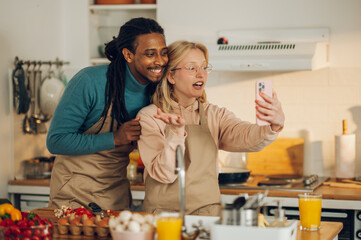 A happy multicultural couple is having a conversation on a video call with friends