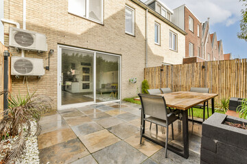 Patio with wooden table and chairs in backyard