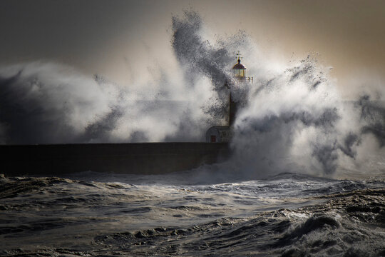 Farol sendo atingido por um forte onda em Porto, Portugal