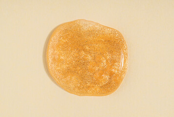 Transparent shimmer golden cosmetic sample texture with bubbles. Cosmetic glittering shower gel. Cosmetic shiny face serum, lotion, moisturizer, beauty background