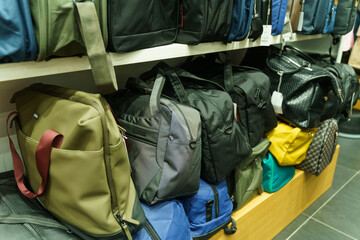 A shop window selling bags, with travel bags on the shelves.