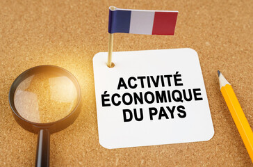 On the table is the flag of France and a sheet of paper with the inscription - economic activity of...