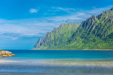 The crystal clear water of the Ersfjordstranda beach in Senja Island,  Norway