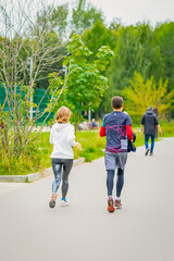 Fototapeta premium Happy couple running outdoors. Fitness, sport and jogging