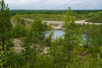 This is a former shale quarry with azure water and picturesque hills. Unlike the Narva shale settling ponds. A dark autumn day. Estonia, Aidu quarry.