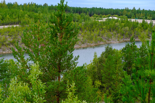 This is a former shale quarry with azure water and picturesque hills. Unlike the Narva shale settling ponds. A dark autumn day. Estonia, Aidu quarry.