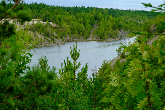 This is a former shale quarry with azure water and picturesque hills. Unlike the Narva shale settling ponds. A dark autumn day. Estonia, Aidu quarry.