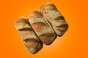 Naklejka premium dark australian bread isolated over orange background