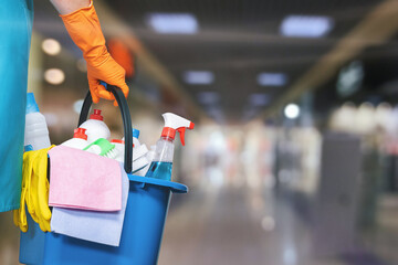 A cleaning lady with a bucket and cleaning products.