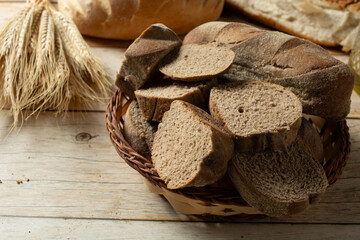 slices of dark bread on a basket. also known as australian bread.