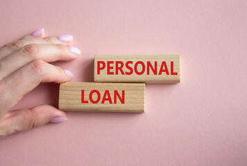 Personal Loan symbol. Concept word Personal Loan on wooden blocks. Businessman hand. Beautiful pink background. Business and Personal Loan concept. Copy space
