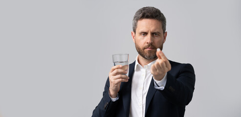 tired business man take painkiller. man ceo offer painkiller for a headache. stressed tired businessman. business overwork. chronic fatigue. businessman taking pill. headache painkiller. copy space