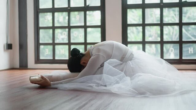 Asian millennial woman practice ballet at studio.