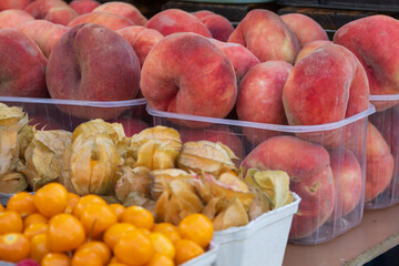 Sweet fruit. Peach on the market counter for sale.