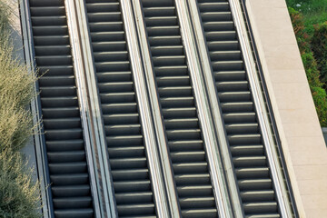 Modern luxury escalators with staircase at airport. Four escalators