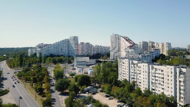 Drone footage captures the grandeur of the city gates, two towering white residential blocks, at the entrance on a sunny summer day.