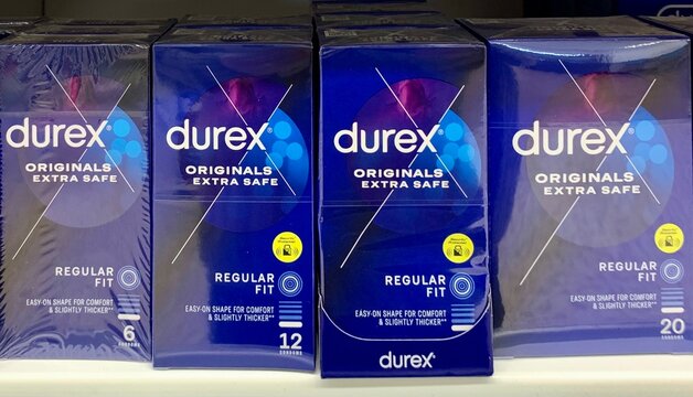 Essex, UK - March 29, 2023: Boxes of Durex originals extra safe condoms for contraception and protection against sexually transmitted diseases on sale in a UK supermarket. 