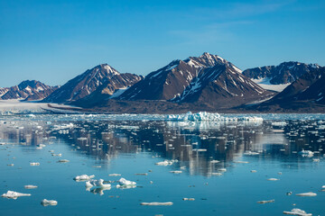 Stunning landscapes with jagged mountain peaks, glaciers and icebergs along the shores of the Liefdefjorden, Northern Spitsbergen, Svalbard, Norway