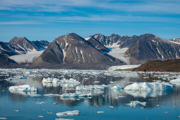 Fototapeta na wymiar Stunning landscapes with jagged mountain peaks, glaciers and icebergs along the shores of the Liefdefjorden, Northern Spitsbergen, Svalbard, Norway