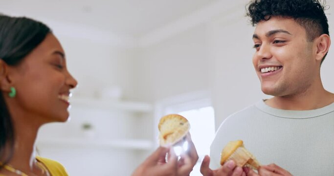 Baking, muffin and happy couple with cheers and love in a kitchen with food and cooking. Smile, young people and dessert in a home with care and marriage in a house together with pastry fun and toast
