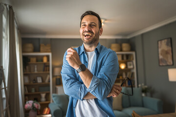 One adult man with eyeglasses stand at home happy smile