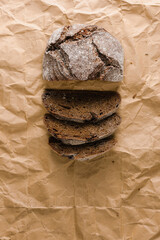 Round rye bread on parchment paper, cut into pieces