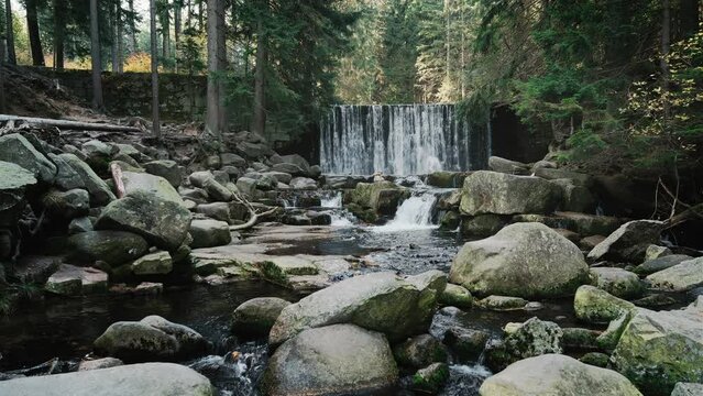 Waterfall, cascades and artificial river dam on a mountain river in the forest, beautiful natural landscape in bleach bypass style, 4k stock video