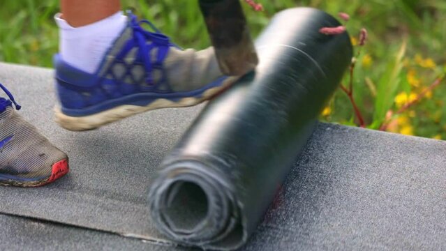 Process of melting roll of tar onto the foundation of a house under construction, waterproofing a developing building, melting a bitumen roll, industrial concept