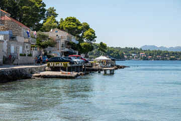 Fototapeta na wymiar Small town of Lumbarda on Korcula island, Croatia with narrow streets and parking spots built above the sea