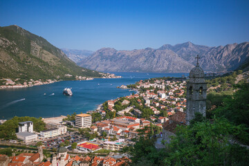 Naklejka na ściany i meble Panoramic view to Kotor bay with Bell tower of Church of Our Lady of Remedy on the slope of Saint John to the right, Montenegro