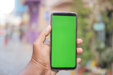 rear view of young man using smart phone at outdoor 