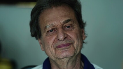 Fototapeta premium Portrait of a happy senior man close-up face, elderly caucasian person in 70s looking at camera chuckling